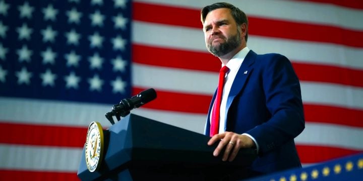 Vice President JD Vance at a podium with an American flag behind him