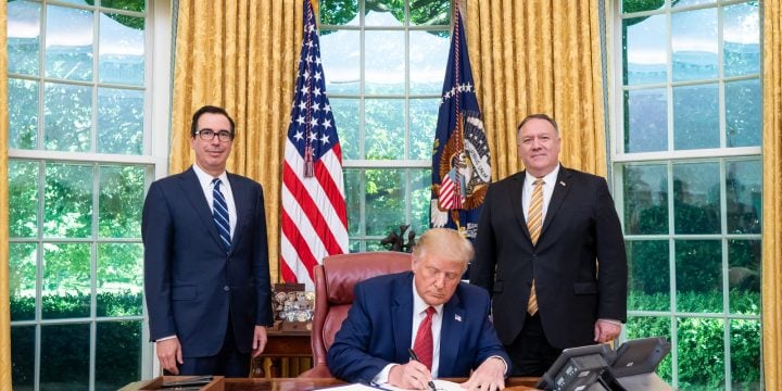 President Trump signs an executive order in the Oval Office