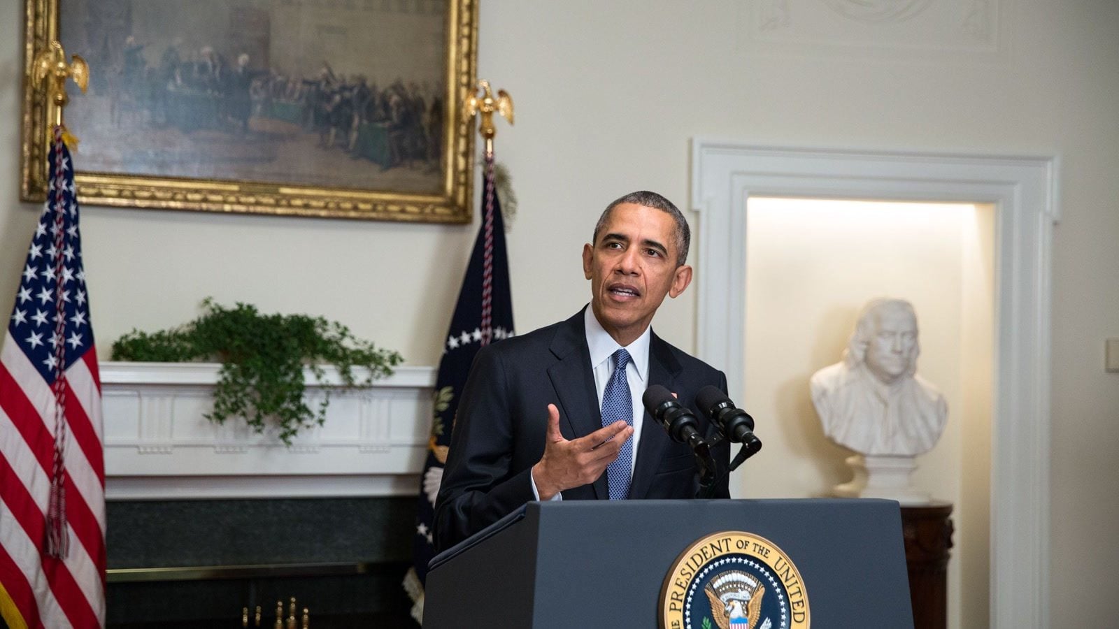 Former President Barack Obama speaking at a White House podium