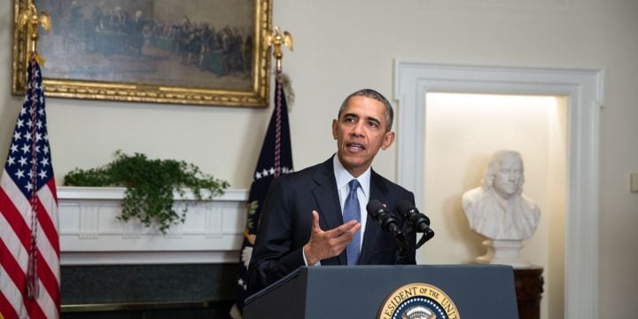 Former President Barack Obama speaking at a White House podium