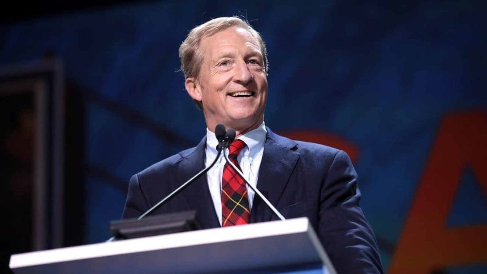 Tom Steyer speaking at podium during California campaign event