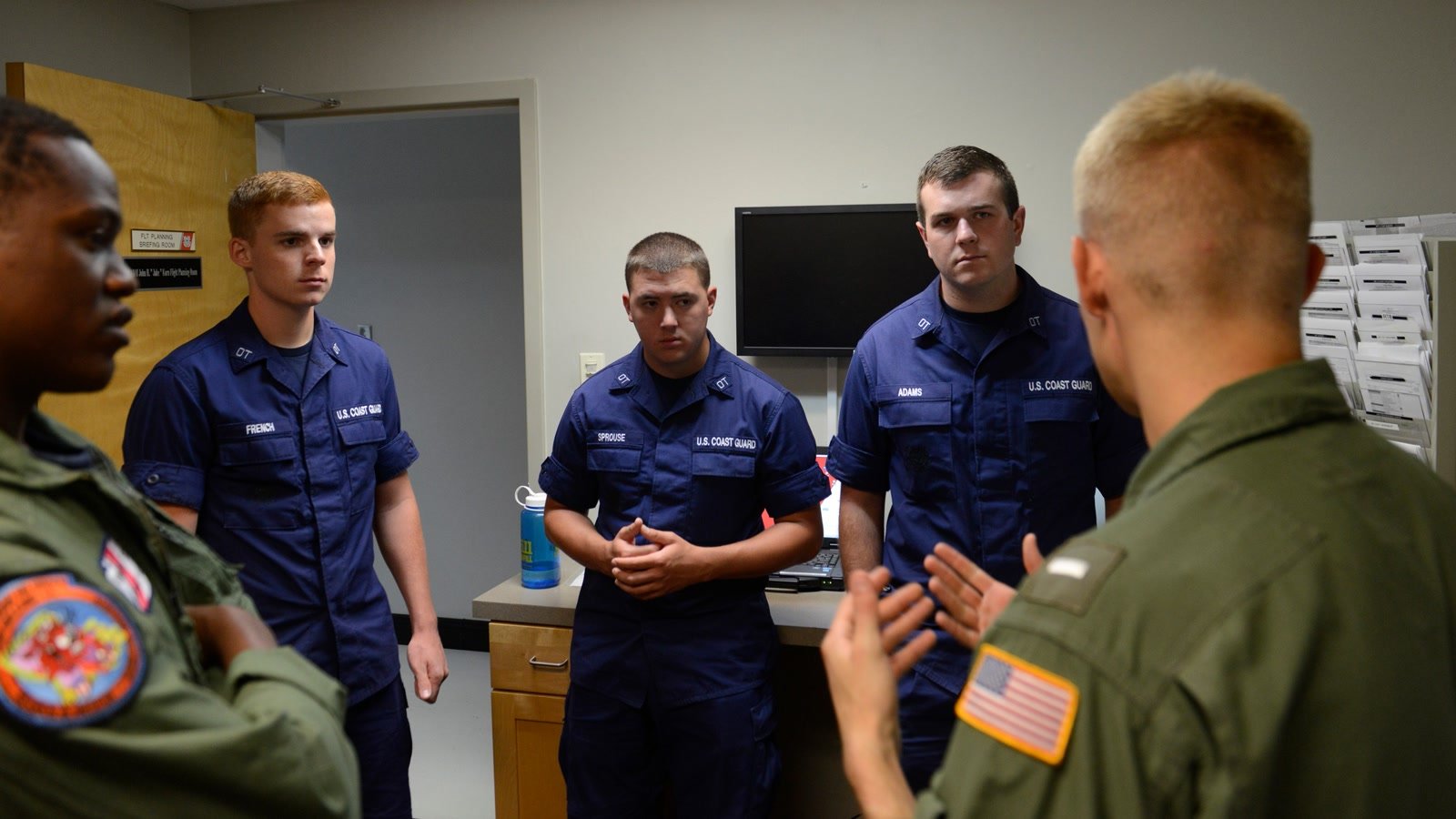 Coast Guard College Student Pre-Commissioning Initiative students receive instruction at Air Station New Orleans