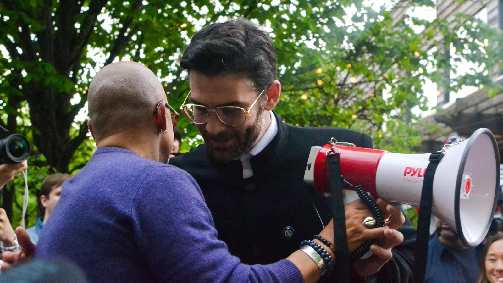 Hasan Piker speaking with another person at a public event