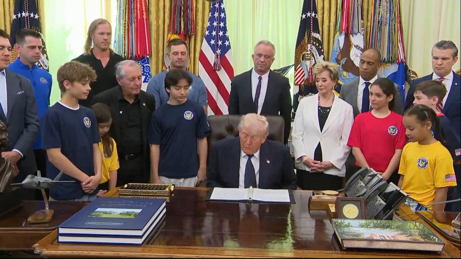 President Trump signs documents during the Presidential Fitness Test relaunch