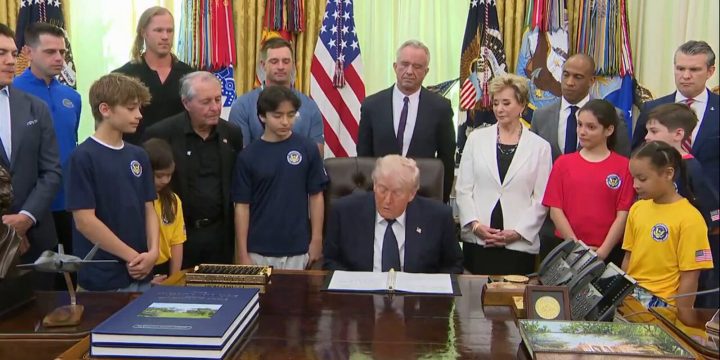 President Trump signs documents during the Presidential Fitness Test relaunch