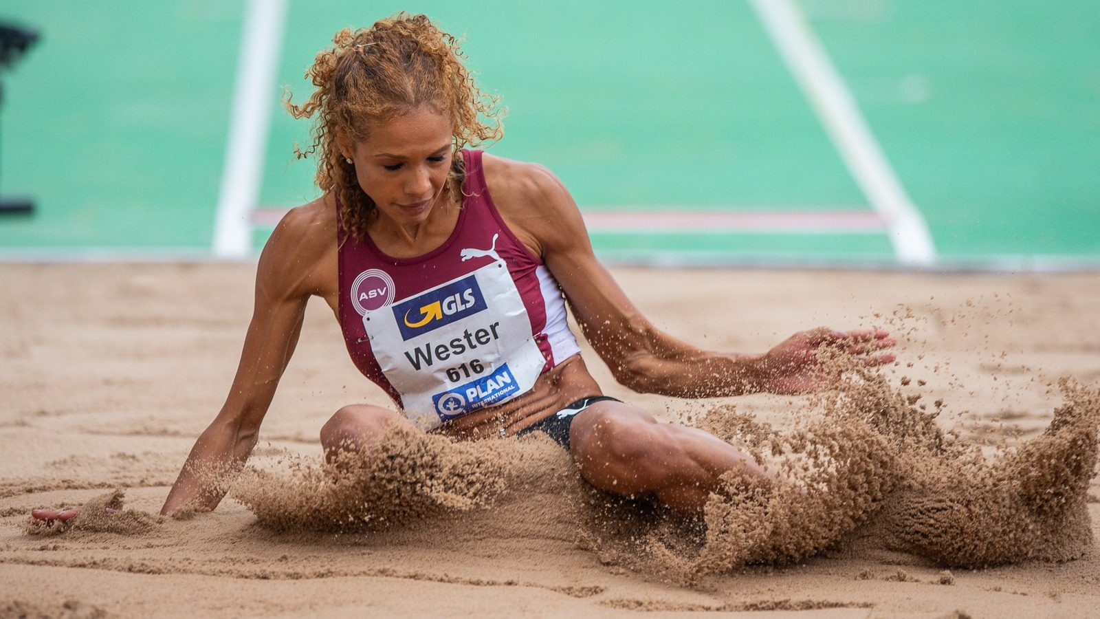 A woman competes in long jump during a track and field competition