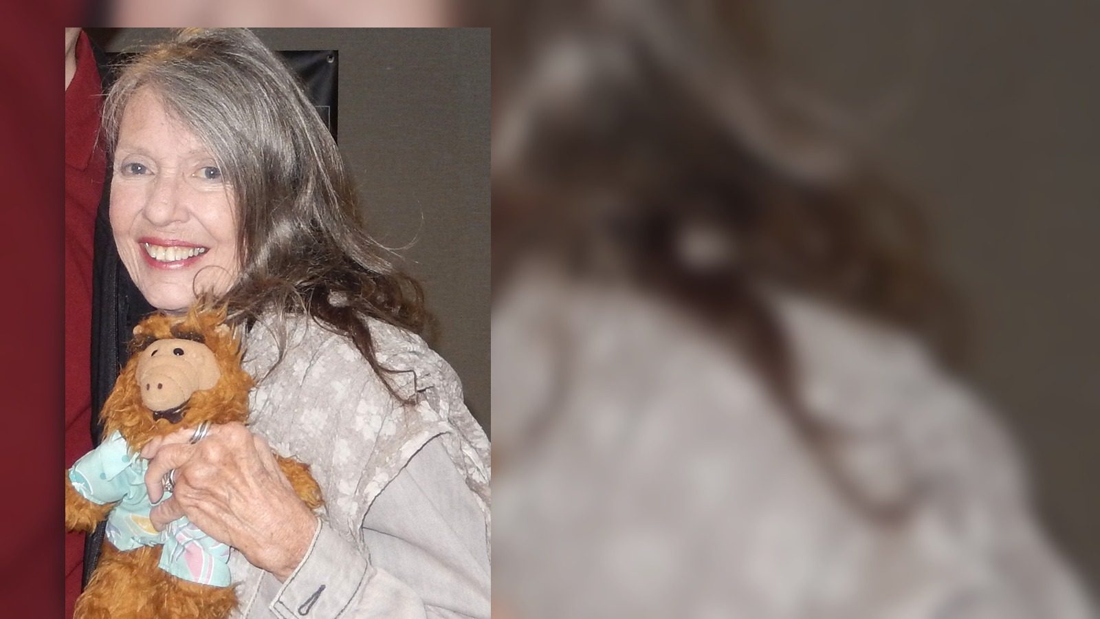 Anne Schedeen smiles while holding an ALF doll at Chiller Theater in 2019.