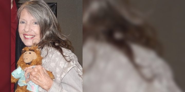 Anne Schedeen smiles while holding an ALF doll at Chiller Theater in 2019.