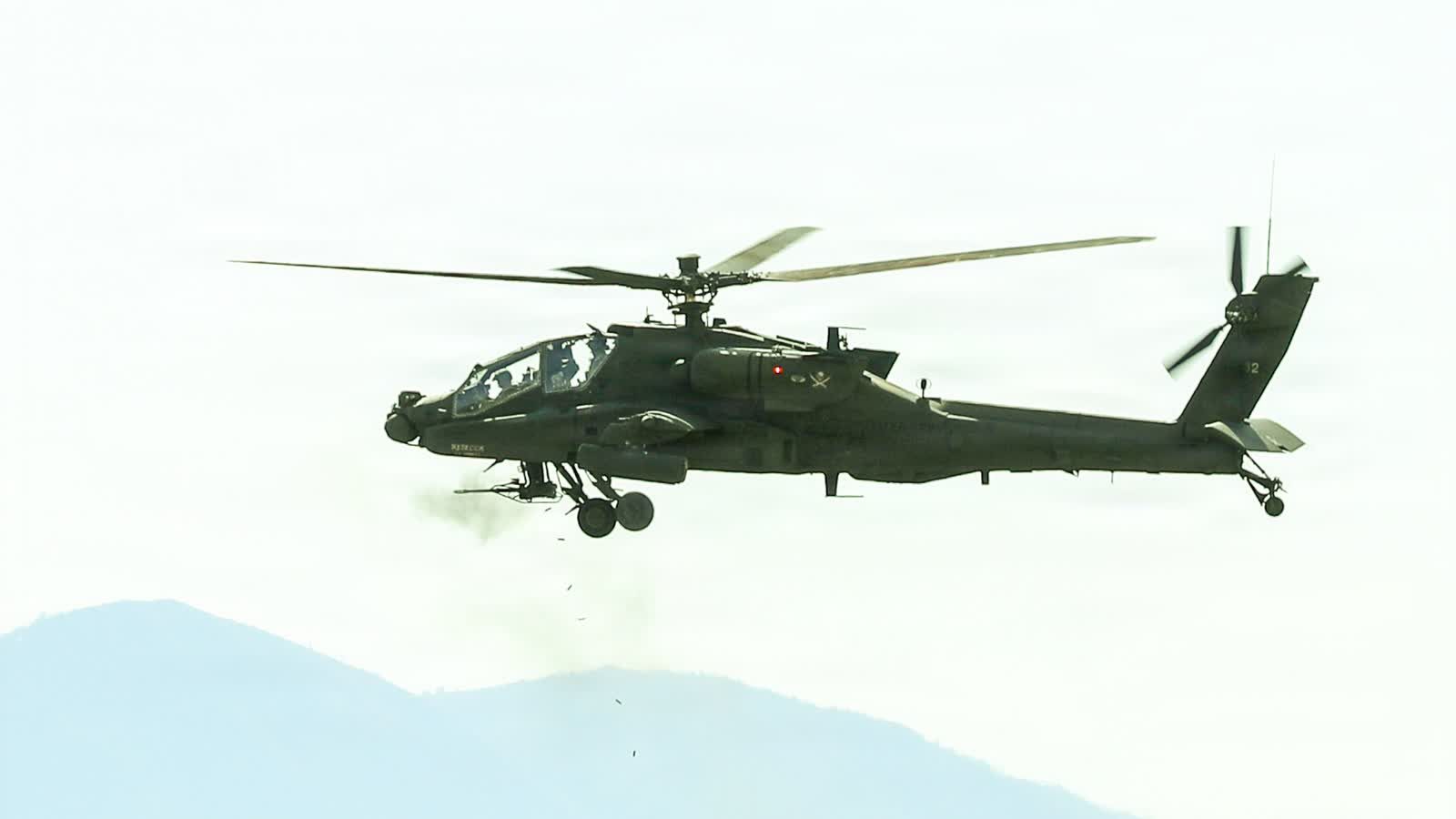 U.S. Army AH-64 Apache attack helicopter firing during a live-fire exercise