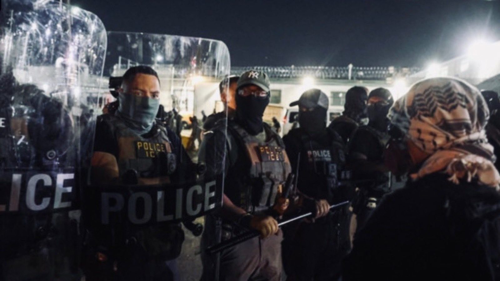 Official DHS photo showing police and ICE officers outside Delaney Hall during anti-ICE confrontations