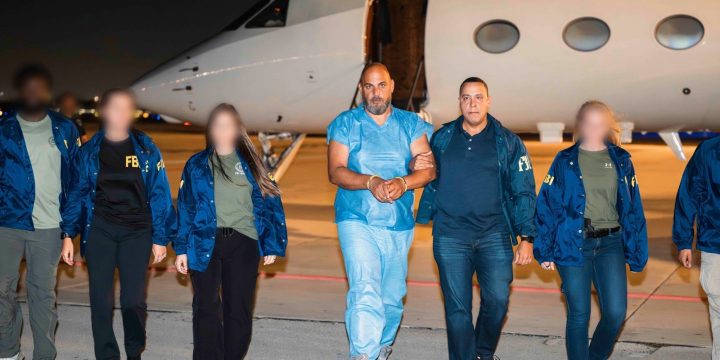 Official photo from the FBI showing Ibrahim Khaldoon Hilmi in custody on a tarmac beside an aircraft