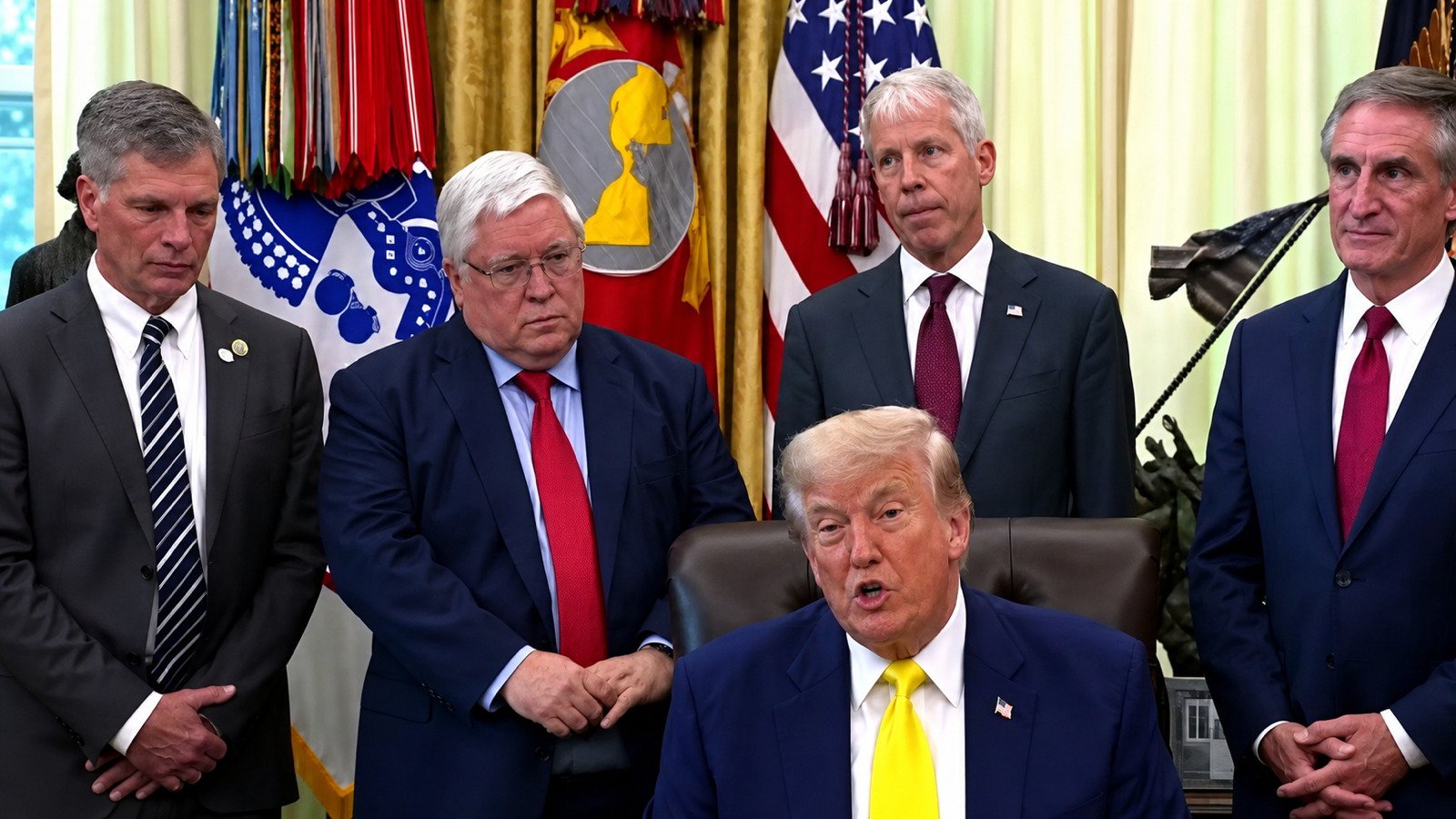 Source video still of President Trump speaking in the Oval Office with officials behind him