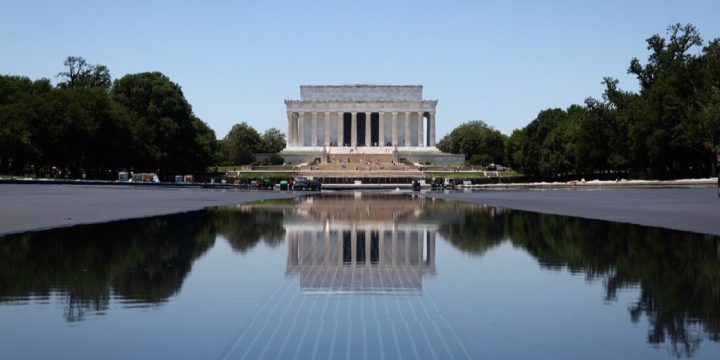 Official White House photo of the Lincoln Memorial reflected in the refilling Reflecting Pool