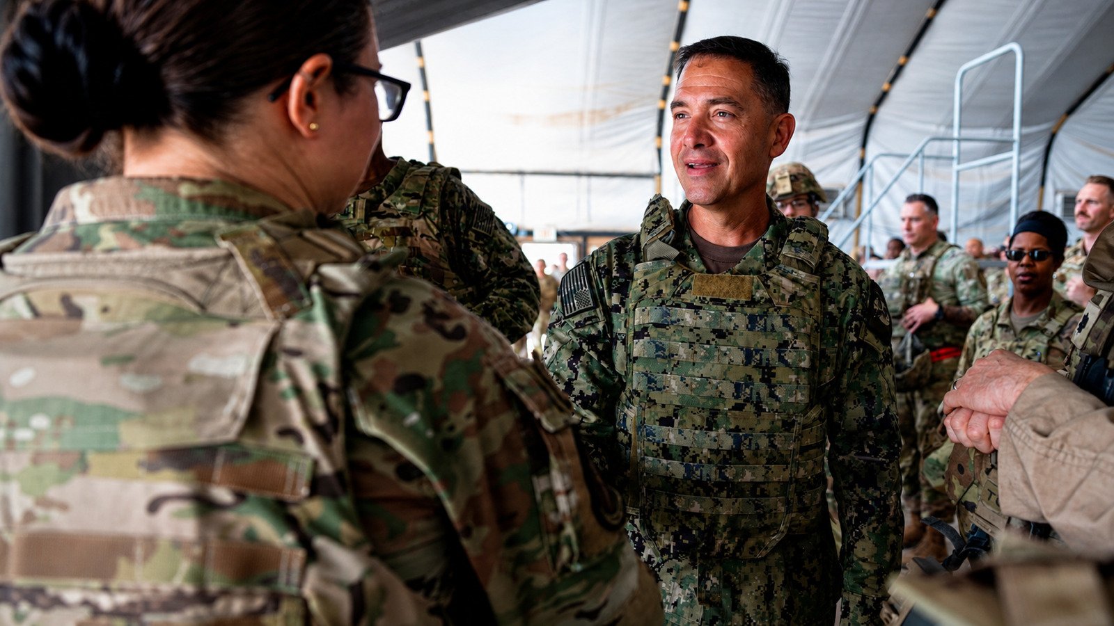 Adm. Brad Cooper speaks with deployed U.S. troops at a base in the Middle East.