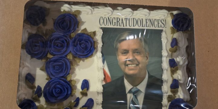 Cake bearing Lindsey Graham's photograph and the word Congratudolences
