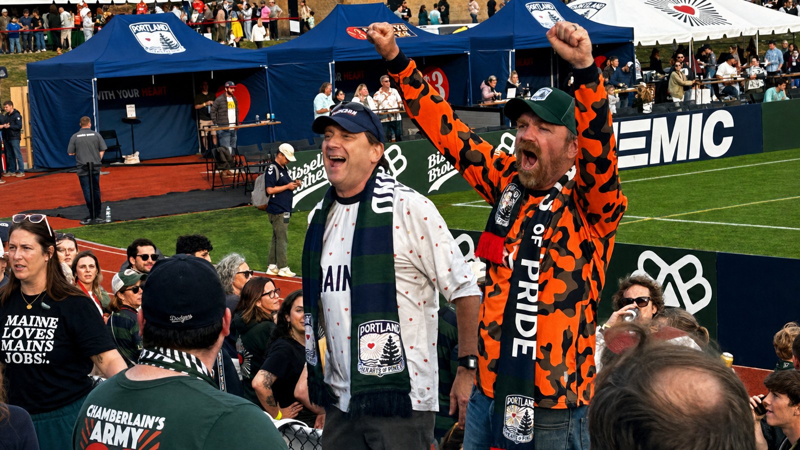 Troy Jackson and Graham Platner cheer at a Portland Hearts of Pine soccer match.