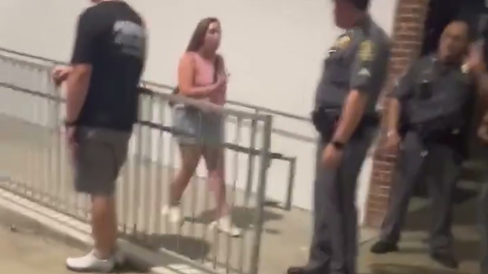 Family members speaking with uniformed officers inside M&T Bank Stadium after a Morgan Wallen concert incident