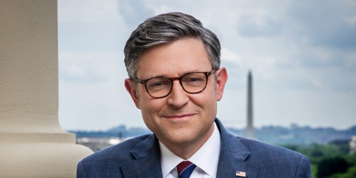 Speaker Mike Johnson in his official congressional portrait with the Washington Monument behind him