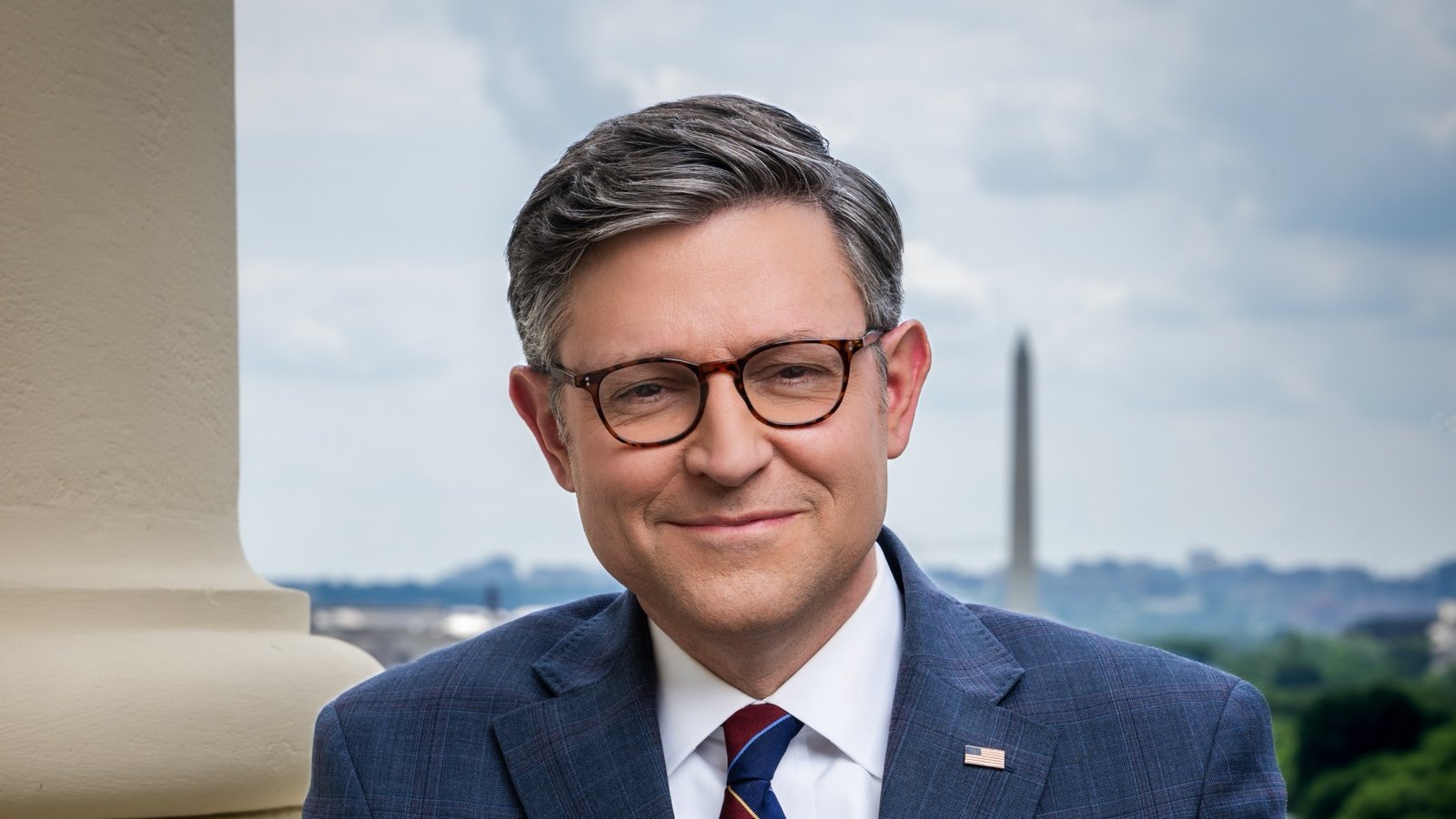 Speaker Mike Johnson in his official congressional portrait with the Washington Monument behind him