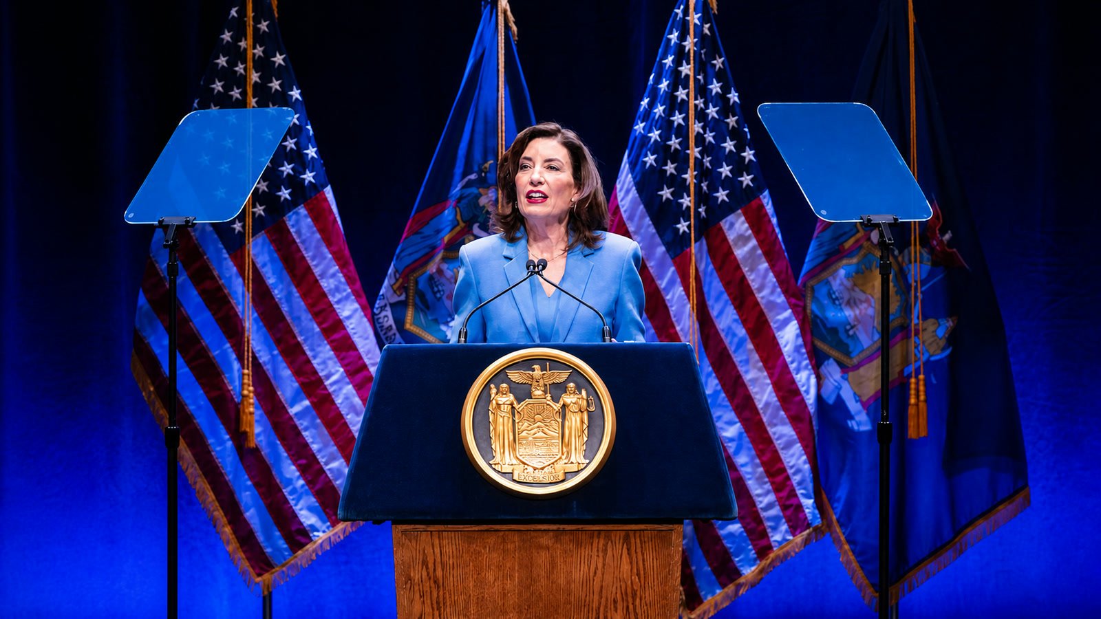 Governor Kathy Hochul speaking at the 2026 State of the State address, with American and New York flags behind her