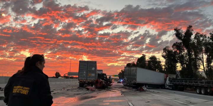 San Bernardino County investigator surveys wrecked trucks after the fatal Interstate 10 crash in Ontario, California