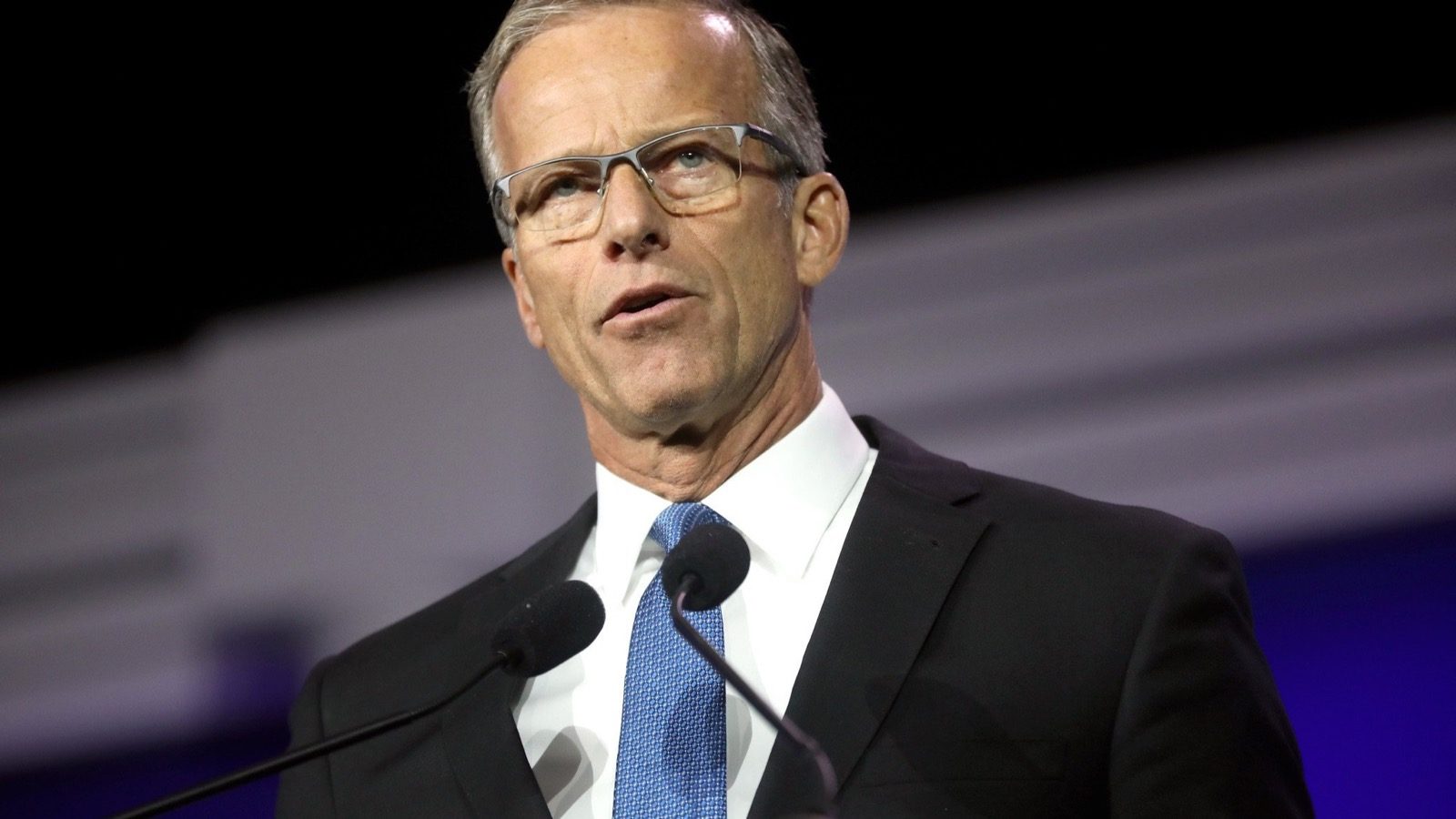 Senate Majority Leader John Thune speaks at a podium