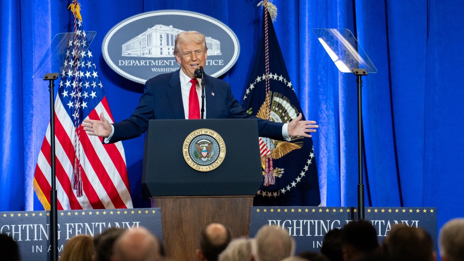 President Trump speaking from a podium at the Justice Department