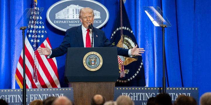 President Trump speaking from a podium at the Justice Department