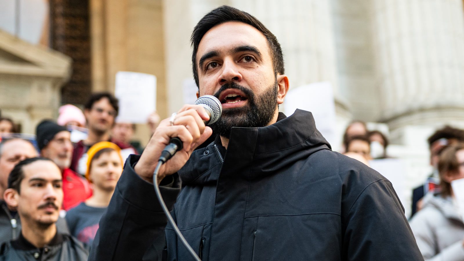 New York City Mayor Zohran Mamdani speaking into a microphone before a crowd