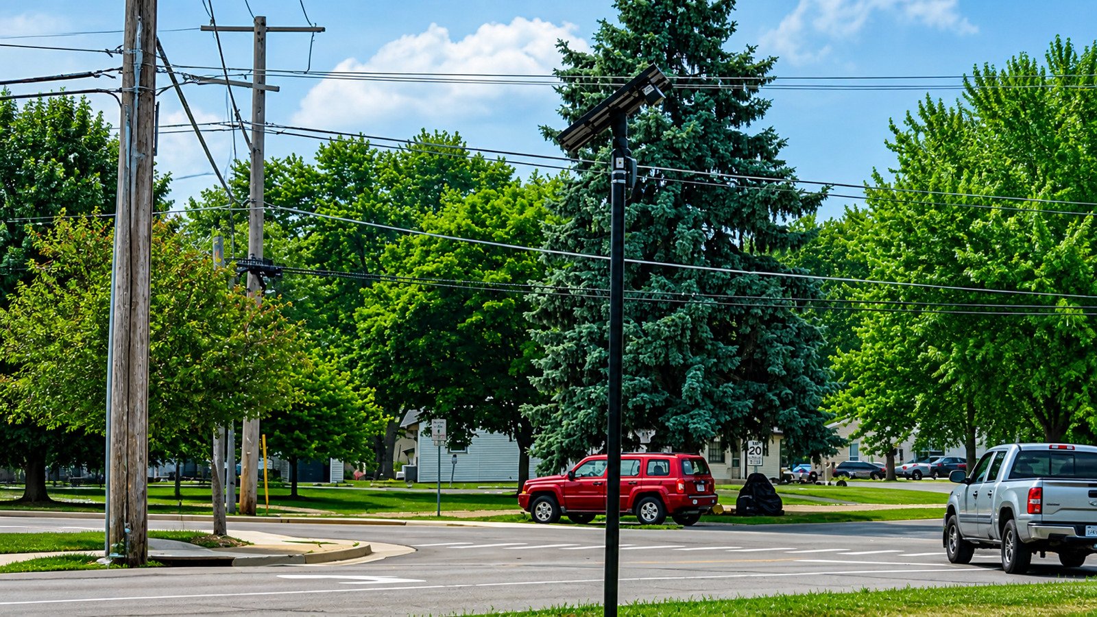 Flock Safety automated license plate reader camera mounted beside a public road