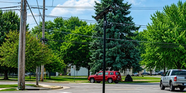 Flock Safety automated license plate reader camera mounted beside a public road