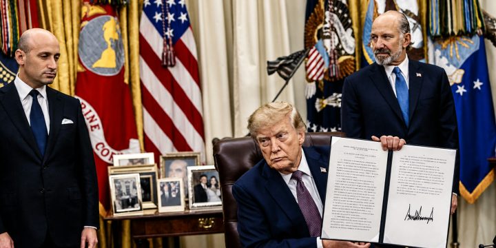 President Trump holds a signed birthright citizenship executive action in the Oval Office