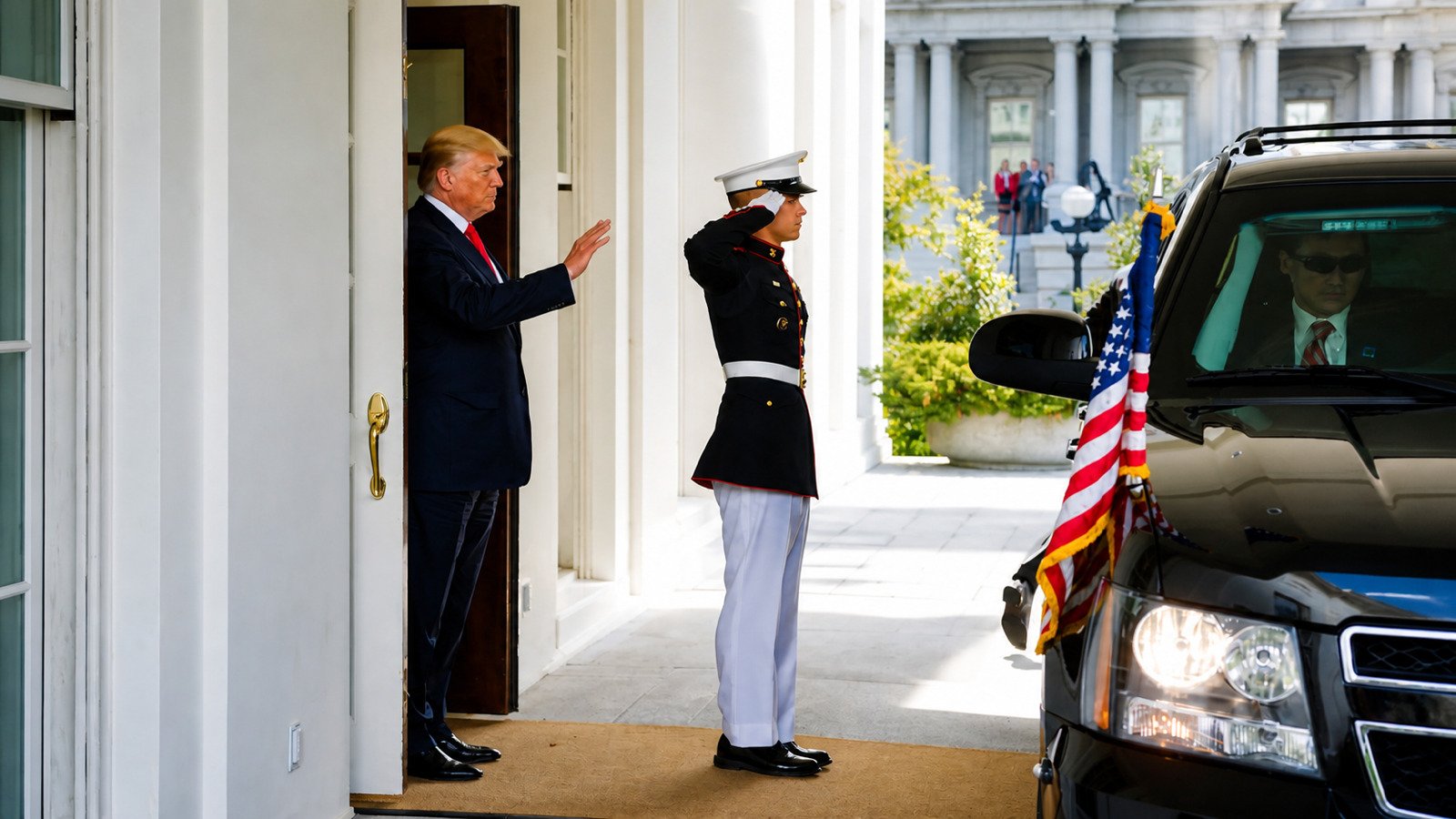 President Trump waves beside a saluting United States Marine at the White House in May 2017